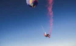 Georg Lettner swinging under a hot air balloon during the Megaswing Project, Austria on July 5th 2016