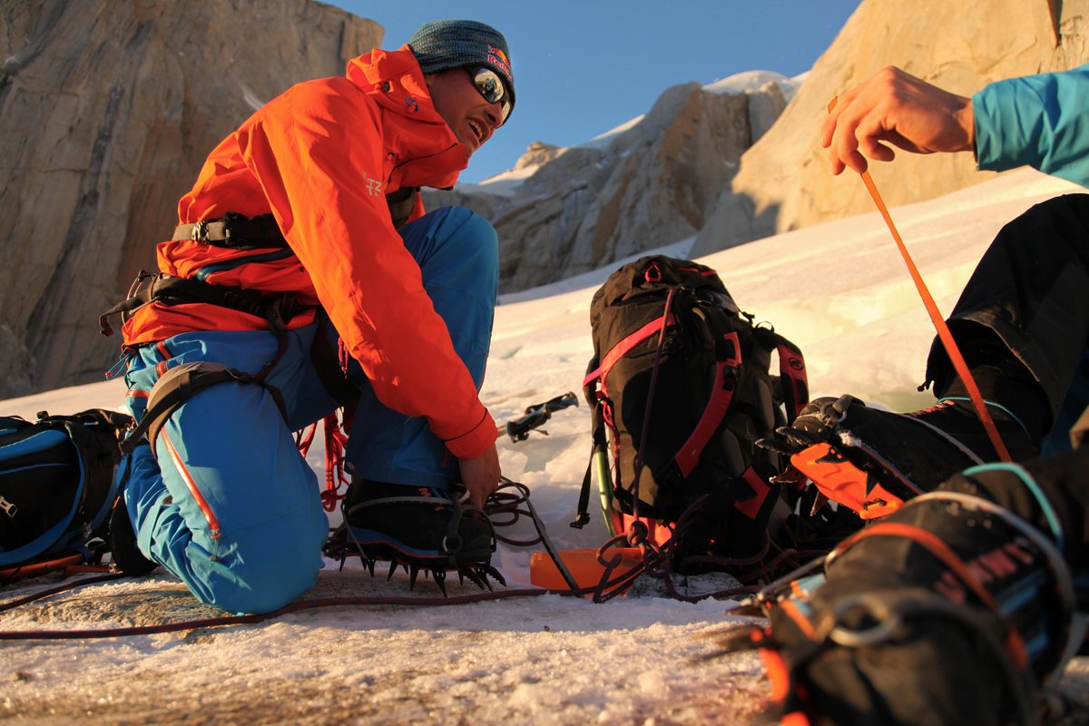 David Lama putting on his crampons to climb up to Col de la Patienca for their attempt on Cerro Torre in Patagonia, Argentina.