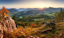 Autumn mountain panorama landcape with forest at sunset